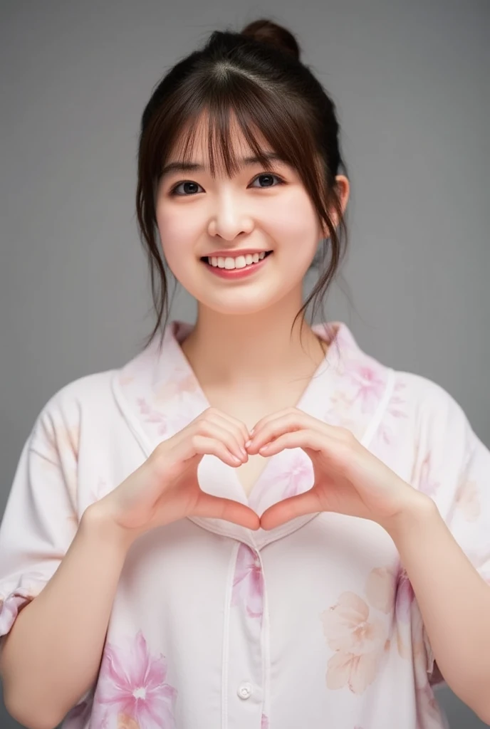 They are wearing off-shoulder pajamas, making a firm big heart shape with both hands, and holding them in front of their chest, View above collarbone、Throat up for a cute smile、Monotone background

