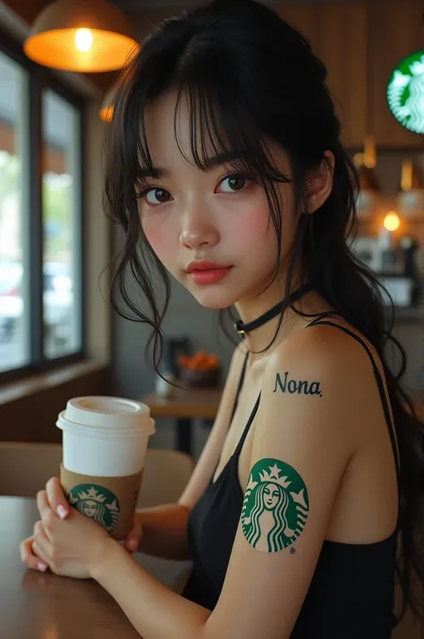 A Korean woman, has the name nona tattooed on her arm, while holding a Starbucks 