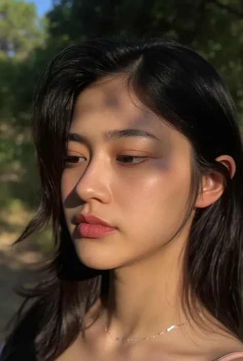 A close-up portrait of a young Thai woman looking downwards with a thoughtful expression. Her face is softly illuminated, with shadows cast across her features, adding depth and a sense of mystery to the image. She has long, slightly wavy hair framing her ...