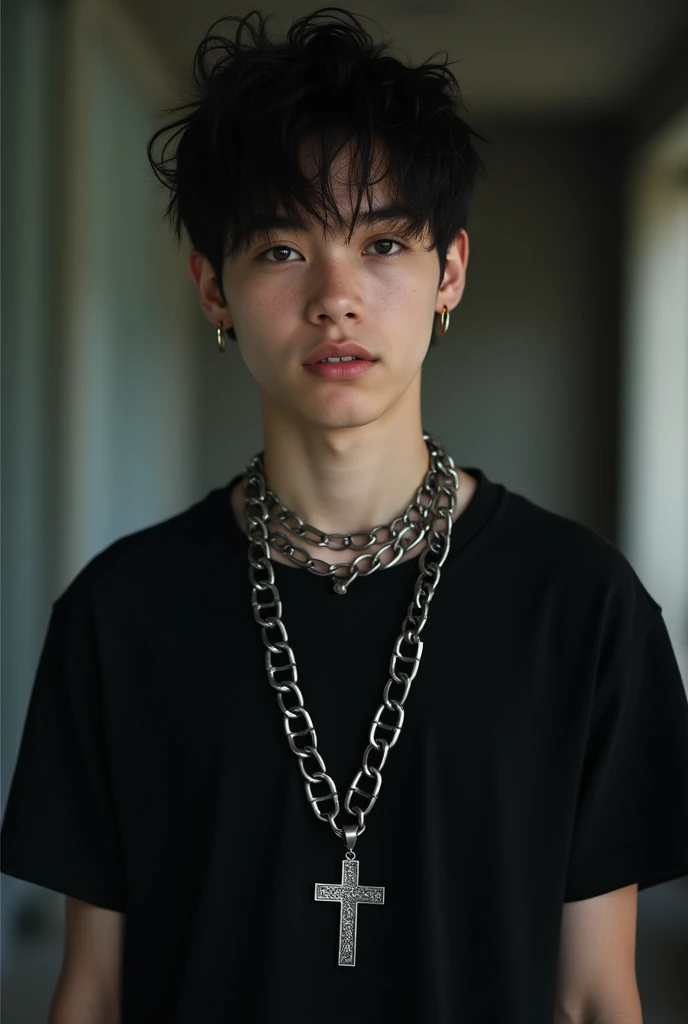 Teenage boy with short black hair wearing black t-shirt with cross chain 