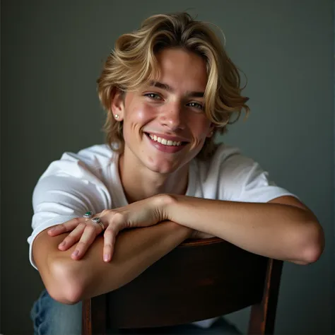 In the midst of a photoshoot, the 16-year-old light-skinned white fair skin male boy model strikes a captivating pose on the chair, his body elevated by the graceful lift of his palms under his chin as hes grinning. His mid-length, thick blonde hair, sligh...