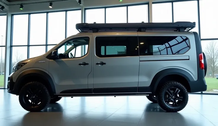 "The side view of the rugged Dacia Sandman camper van in a bright showroom with large glass windows. The camper van features a matte gray exterior with black off-road tires and robust rims, a roof rack on top for storage, and multiple side windows designed...