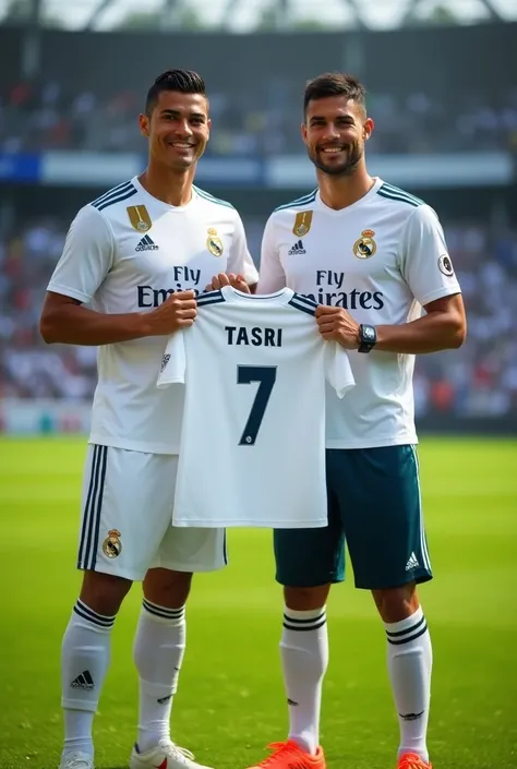 Photo of ronaldo An Real madrid soccer player next to an indonesian man wearing an Real madrid jersey,they are holding a soccer shirt that says TASRI 7.he is standing on the grass field.the background contains a stadium with blurry seast and other people.t...