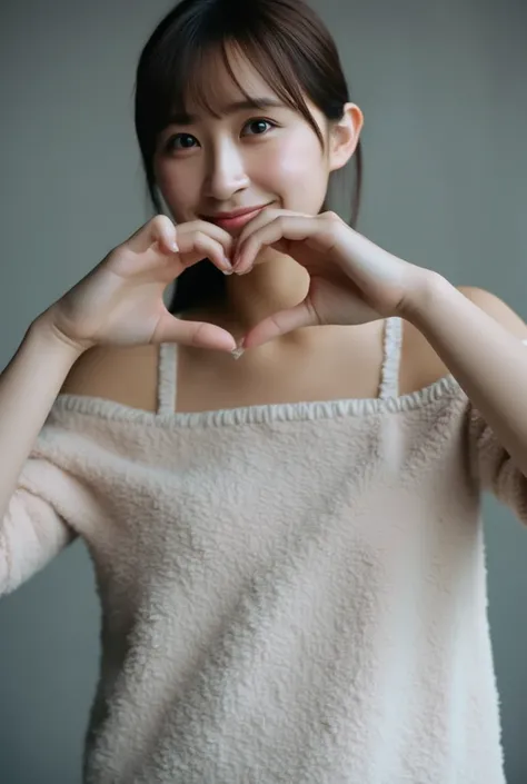 Only one woman with a cute smile wears cute, fluffy off-shoulder pajamas, makes a big heart shape with both hands, and poses them in front of her chest, View above collarbone、The background is a monotone 

