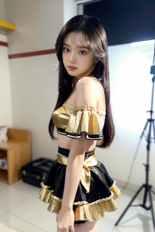 The 25-year-old Thai model has pale skin and her long, highlighted brown hair falls down over her shoulders. She wears a trendy, invisible tube top with short, light-colored sleeves, a bright white bodycon dress, and a black skirt with gold stripes. Her sk...