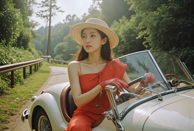 A woman driving a 1954 Jaguar Roadster. The womans face is that of a very pretty Korean girl. The glamorous woman is wearing a red dress and a travel hat. Her car is driving on the road.