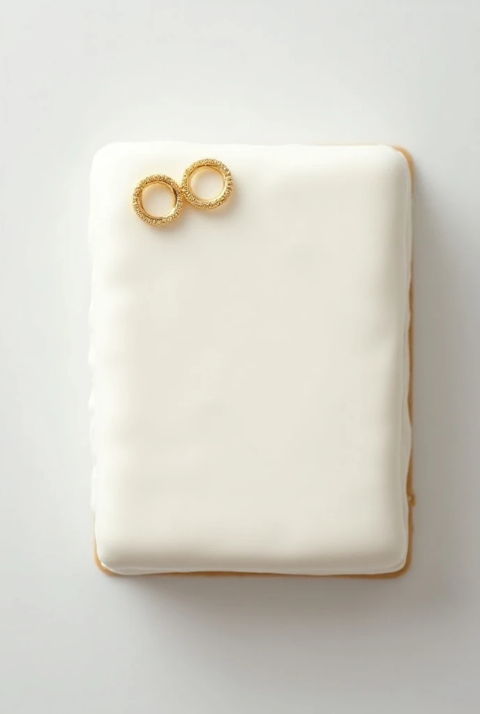 white cake with golden rings rectangular from above 