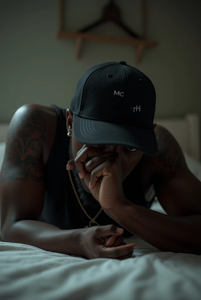  A black rapper with a cap covering his face, lying on a bed after making love , Put the sentence: "MC APH"