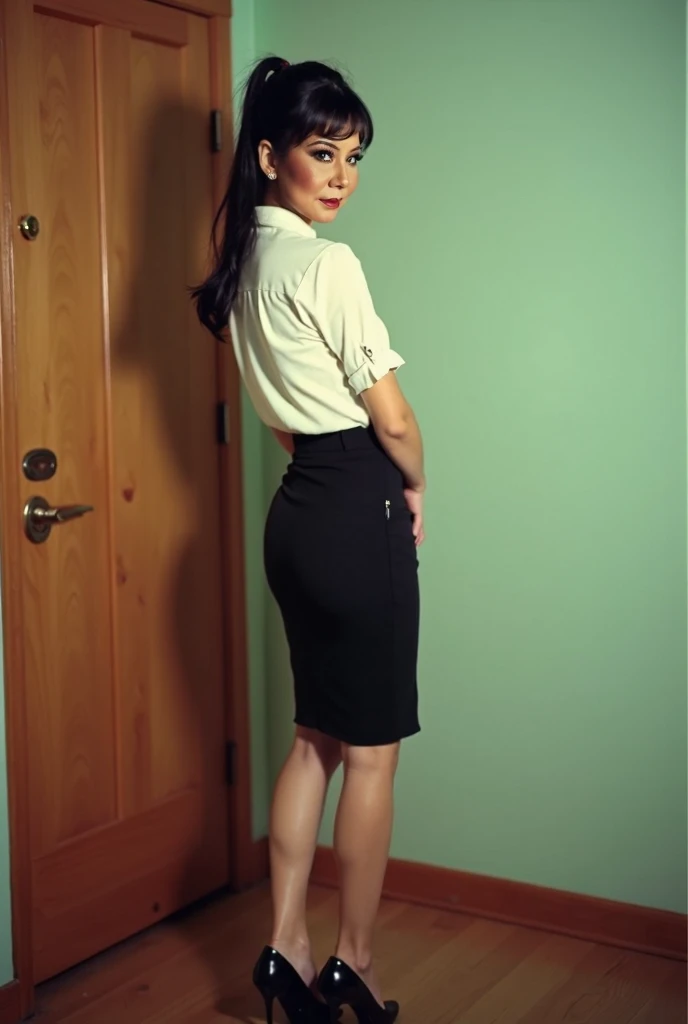 retro grainy image. a mexican woman about 28 years old, light skinned, brown eyes, black hair in a ponytail. she is wearing a white cotton blouse, a black nylon pencil skirt, and black high heels. she is posing with her back turned in a mint-colored room n...