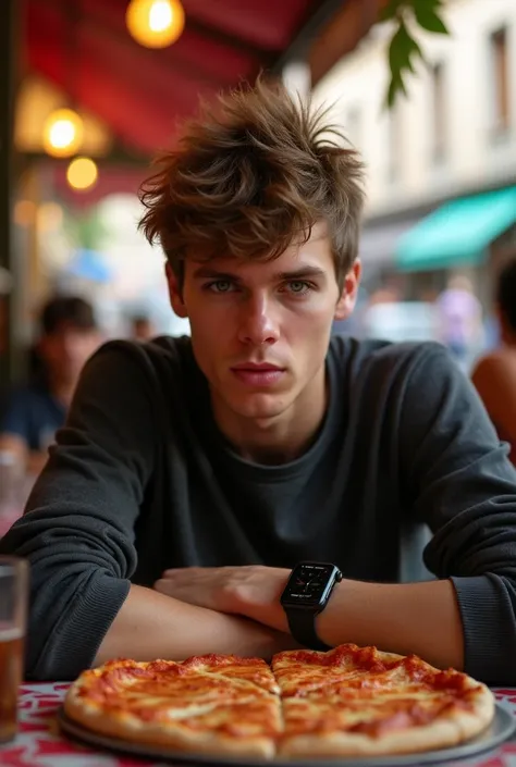 My 18-year-old son with messy short hair is about to eat a pizza in a pizzeria in Barcelona with an apple watch on his wrist and a long-sleeved shirt staring intently at the camera.