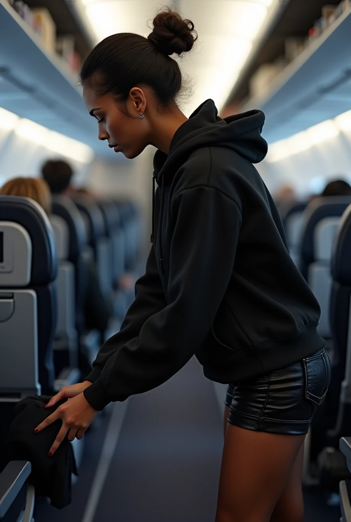 black woman hair in a bun black hoodie black leather short short bending over the seat in front of her getting something from the cabinet department on the plane. backside view hyper realistic 8k clothe folding
