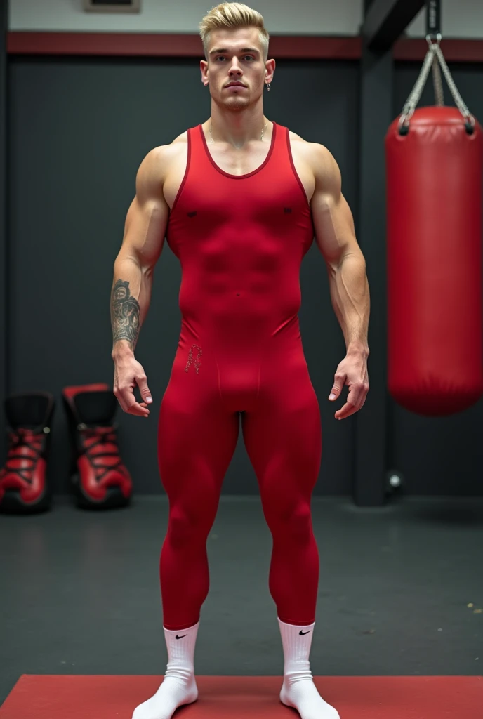 full length view, one young blond muscular sporty guy with stylish undercut haircut and diamond small earings , wearing a red underarmour lycra jumpsuit showing off his huge massive pecs & big bulge, white nike socks, no shoes, waiting standing in socks in...