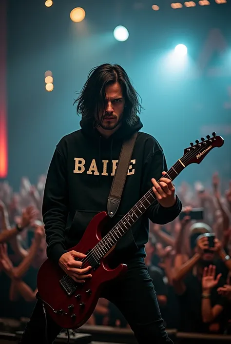 thin man, medium length black hair, wearing a hoodie that says baipe, on stage at a metal concert, poses looking at the camera, playing guitar with a crowd of spectators