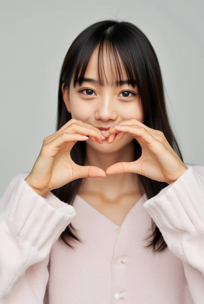 Only one woman with a cute smile wears cute, fluffy off-shoulder pajamas, makes a big heart shape with both hands, and poses them in front of her chest, View above collarbone、The background is a monotone 、
