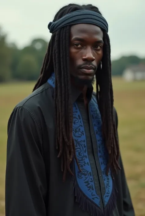  Black Hebrew Israelite man with really dark skin, he has long black dread locs he has a full bread that frames his face,, he is tall, and lanky, Mitre head band, He is wearing a black shirt with a border of blue with fringes on the bottom hem, he is cold,...