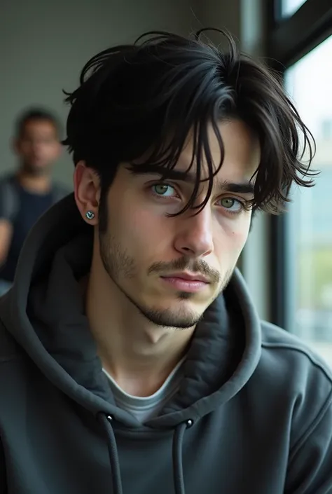  Young man with straight black hair ,  slightly curled and messy just above the shoulders,  greenish brown eyes ,  3 piercings in the left ear , barely apparent beard ,  wearing a sweatcoat and with an expression of boredom  