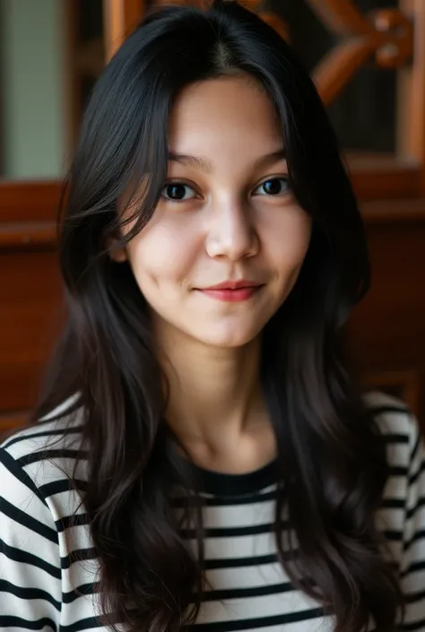 Close-up selfie of a young Southeast Asian woman with long, dark hair, and a dimple on her right cheek. Shes wearing a black and white horizontally striped shirt with a simple crew neck. Her hair is parted down the middle, and some strands fall over the fr...