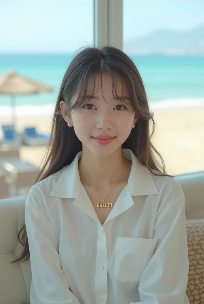 A girl sitting on a sofa wearing a white shirt and a necklace with her name on the background of Atara beach, Korean style