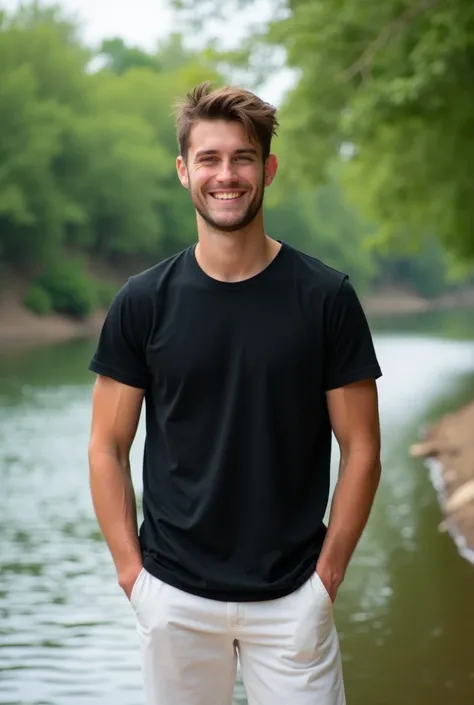 A realistic photo of a 20 year old boy standing on the river bank wearing a black t shirt and white pants smiling at the camera