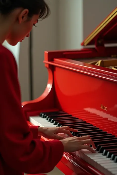 A person wearing a red sleeve plays a beautiful melody on a vibrant red piano.