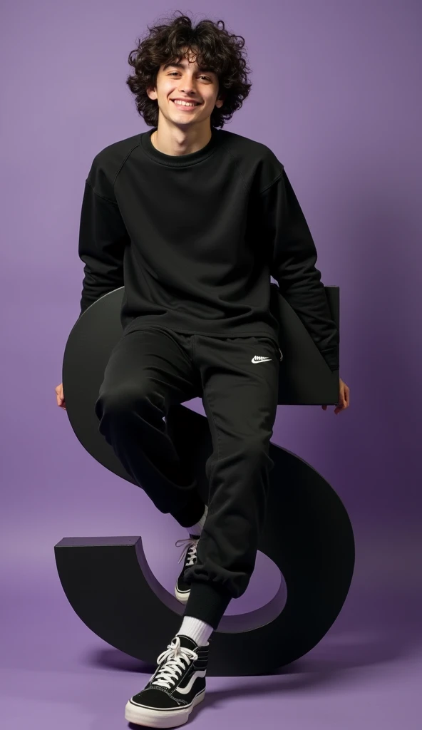   an 18 year old boy， have dark curls  , shows a gentle smile on the face  ,  wearing casual clothes ， include a black pullover , The jogger pants , and sneakers .   This person rests on a large, smooth purple “S”,  which one is black with white accents . ...