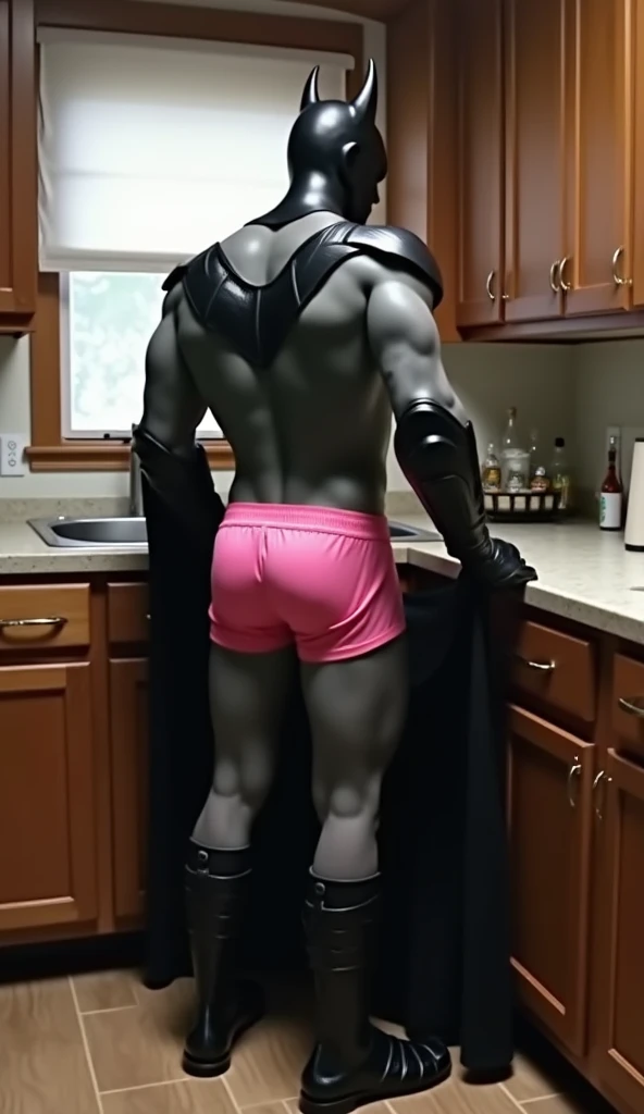 Realistic Batman in the kitchen, with his back turned, with his hands on the counter, with his ass in a sexual pose, pink swim trunks, pink underwear, pink panties, looking back, wearing black crocodile sandals. IMG_1025.HEICIM