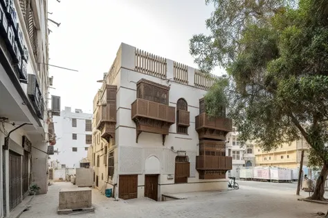 is a view of a building with a lot of windows and a tree,   old jeddah street  ,   old jeddah street  ,  arabic architecture ,  ...