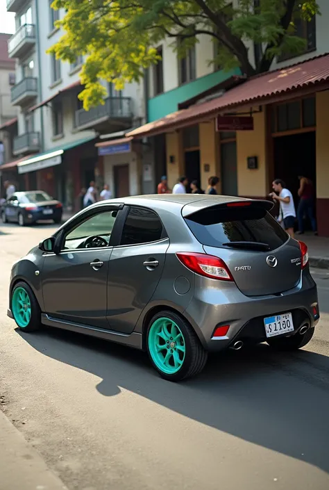 Photo Mazda Alegró gray hatchback model 2002 with low turquoise green striker wheels photo taken from profile on Colombian street 