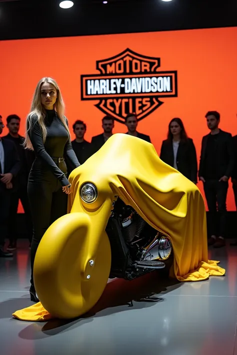 A sleek, modern (2025 Harley-Davidson CVO Road) partially covered wIth clothes displaying a prominent (Harley Davidson) logo, being unveiled by ten people. The bike is a vibrant Yellow with a streamlined design, positioned in an indoor showroom with bright...