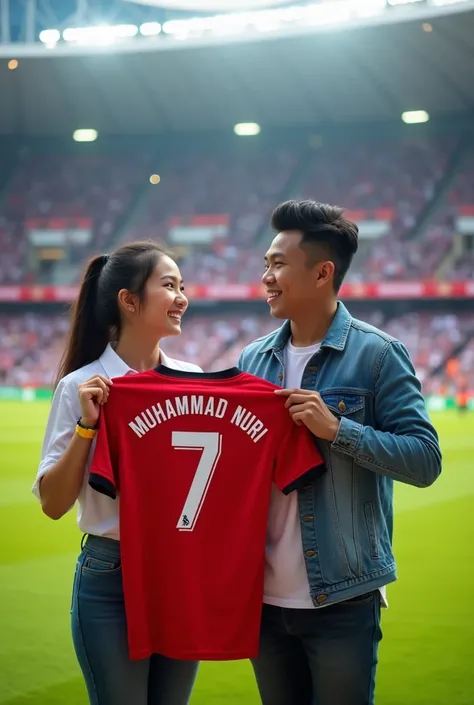 Photo of miyabi next to an Indonesian man with neatly trimmed hair wearing a Denim Jacket, they are holding a football shirt that says "Muhammad Nuri" Number 7. He is standing on the grass field. The background contains a stadium with blurry seats and othe...