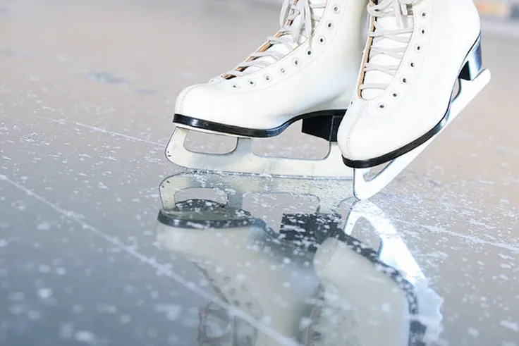 All-scratched ice rink with a pair of skates on the side of the scratches