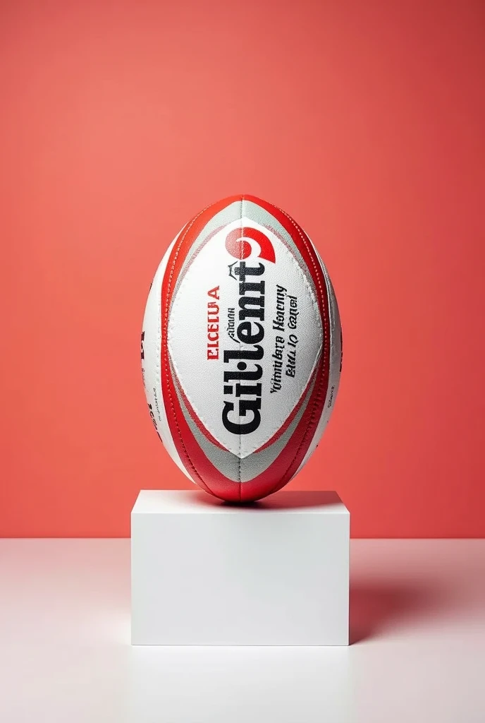 Ballon de rugby rouge et blanc marqué Gilbert dedans avec une pancarte blanche dessous