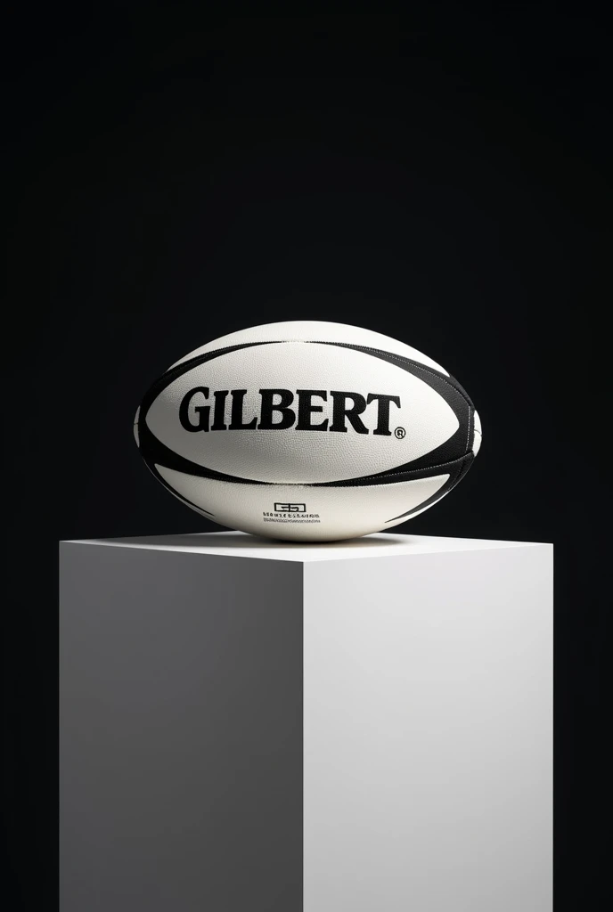 Ballon de rugby marqué Gilbert dedans poser sur un cube blanc le tout dans un fond noir