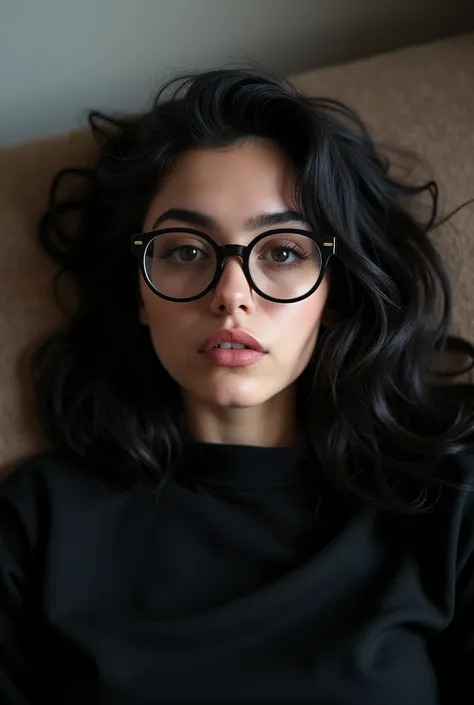 arafed woman with glasses and a black shirt laying on a couch,  An image inspired by Ion Andreescu ,  Instagram , tachisme, nodded, violet myers, 18 years old, with glasses,  wears Harry Potter glasses ,  taken in the early 2020s ,  Long wavy black hair an...