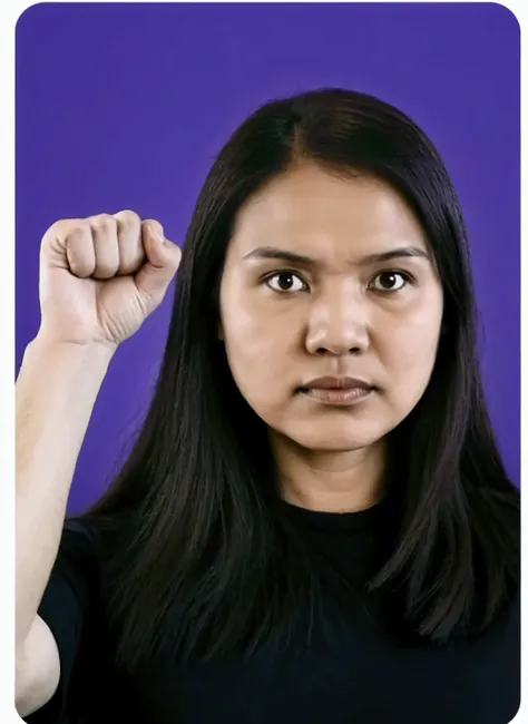 woman with a clenched fist next to her face