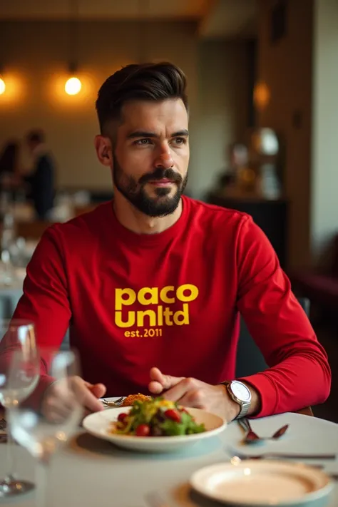 A handsome man with a well-groomed beard, sitting at an elegant and luxurious restaurant. He is enjoying a meal at a beautifully set table with fine dining elements, like crystal glasses and silverware. He is wearing a vibrant red long-sleeve t-shirt with ...