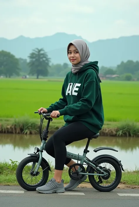 Indonesian woman, 20 years . Wearing Hijab, slightly fat body wearing a dark green hoodie with Ae logo. Wearing black 3/4 Size Leggings. Wearing sneakers. posing sitting on a Folding bike facing the camera on the side of the road, the background is a green...