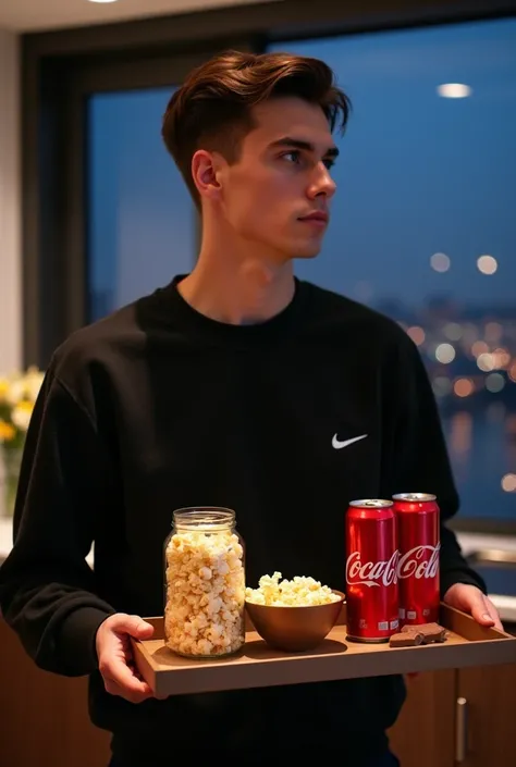 Photo of a man looking forward . 23 year old man,  short, smooth brown hair ,  brown eyes . Wearing black sweatshirt Nike ,  is in a luxurious and modern kitchen at night with a view of London.  With a tray with two jars of popcorn ,  chocolate bars and tw...