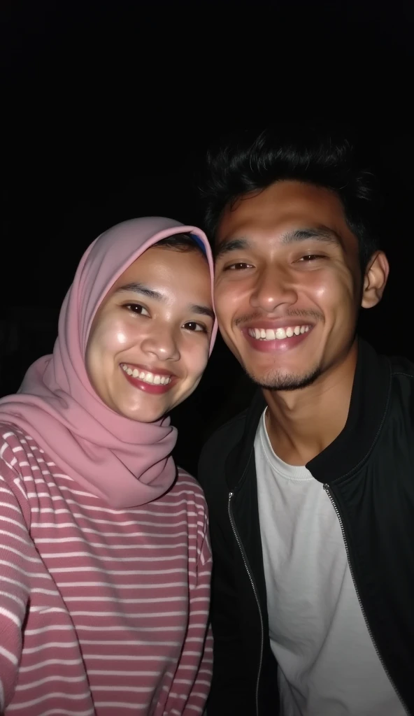 two Indonesian teenage people selfie, girl wearing a pink striped sweater and pink hijab, guy wearing black jacket at night  tall guy, short girl, a small smile 