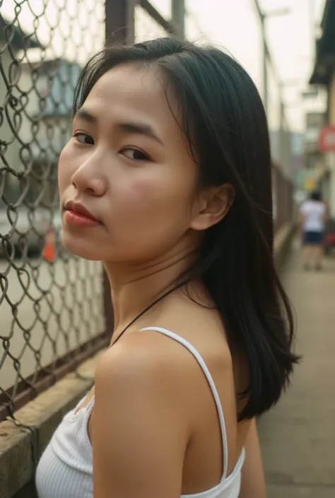 Gorgeous Korean woman is seen behind her back against a chain fence  , A warm bath , , golden light . , her facial expression is intense and focused  , , a sharp shadow flows across the face from the fence  ,  accentuates her appearance . Wear a tank top. ...