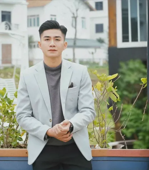 arafed man in a gray jacket and black pants standing in front of a house, in style of lam manh, hoang long ly, quy ho, nivanh chanthara, yanjun chengt, phong yintion j - jiang geping, dao trong le, taken in the early 2020s, 2 