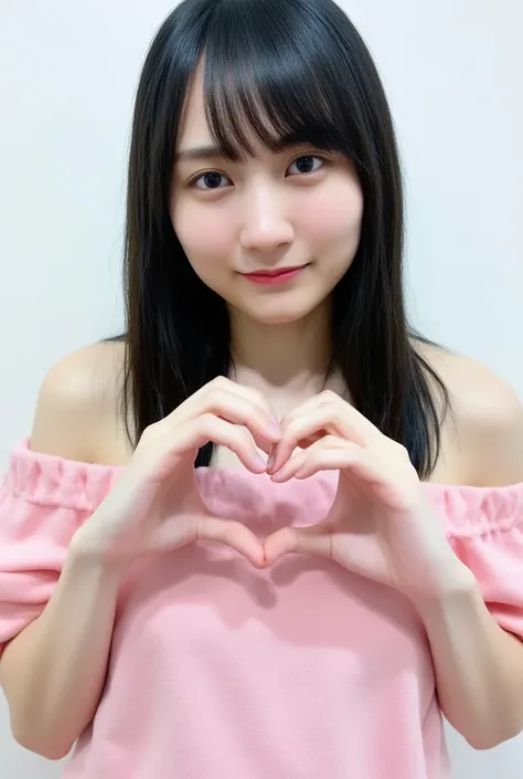 A smiling woman poses alone wearing off-the-shoulder pajamas in pastel colors that convey warmth simply by touching them softly and softly, making a firm, large heart shape with both hands, and holding them in front of her chest, View above collarbone、The ...