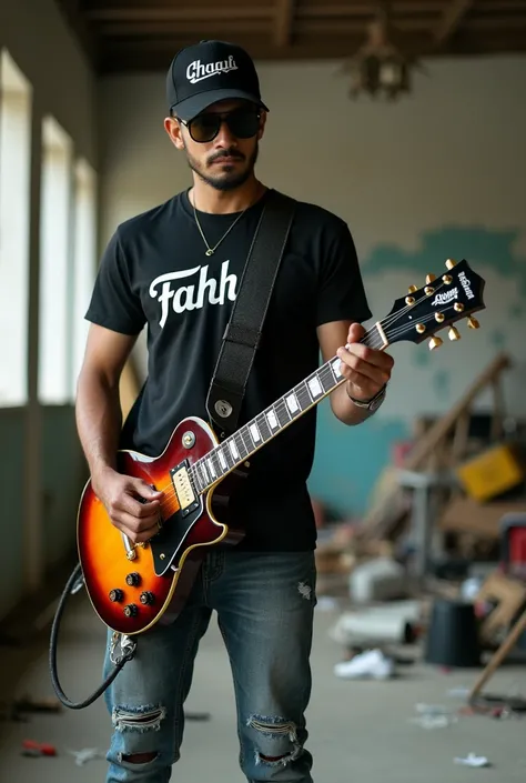 Clean and handsome Indonesian man wearing ripped jeans wearing baseball cap inscribed dhegol wearing boots wearing black t-shirt saying FAKHRI wearing sunglasses playing Gibson electric guitar inside empty building cluttered face appears looking at camera