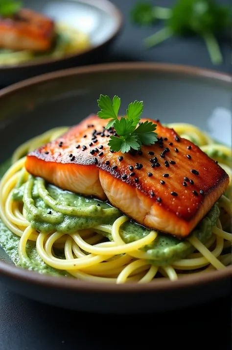  The image shows a plate of spaghetti with a golden salmon fillet on top .  The salmon is covered with a creamy green sauce that looks like fresh herbs and is decorated with small seeds of black sesame
. Besides, there is a touch of fresh parsley on the sa...