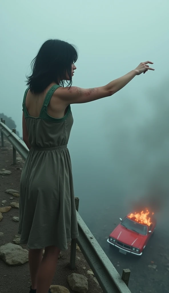 "View from a high cliff on a foggy day. In the foreground, a woman, around 35 years old, European, with shoulder-length black hair, short bangs at eyebrow level, and subtly wavy hair, stands with her back to the camera. Shes wearing a sleeveless, dirty, gr...