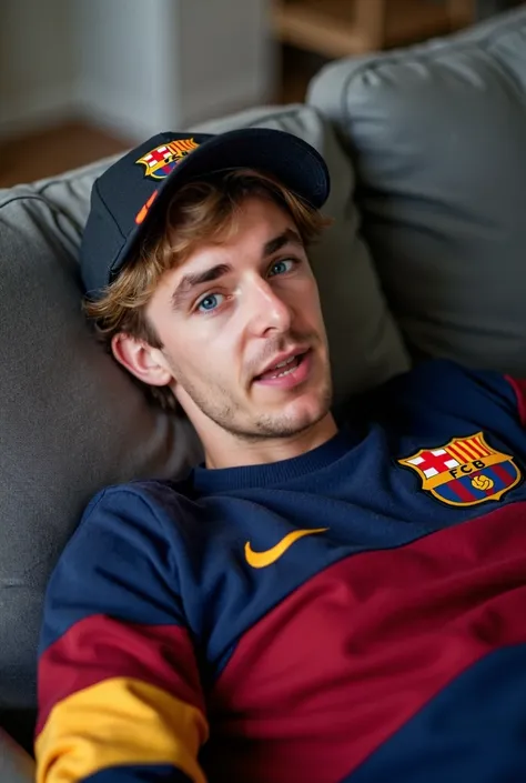 My dad took a picture of me Im lying on a couch Im a 19-year-old man with short wavy hair I have a Barcelona sweater Im wearing a Barcelona cap 