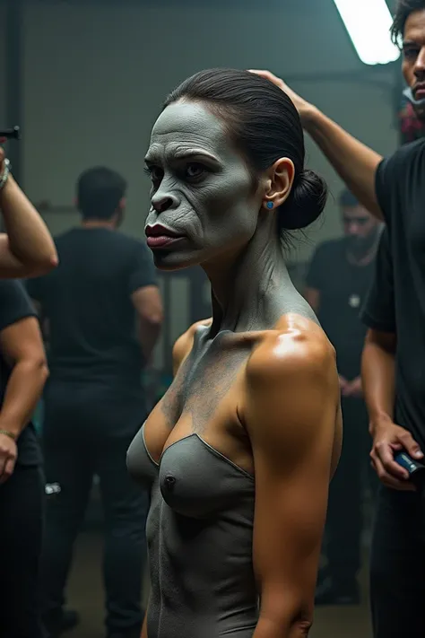 A beautiful latina woman naked low hairbun standing up straight without facial expression is undergoing the process of becoming a gorilla, Crews are attaching a full face prosthetic mask to the womans head to make it look like a gorilla., At the same time,...