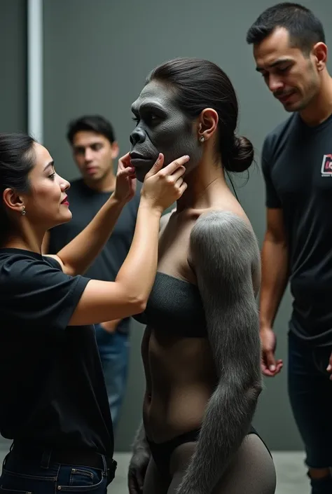 A beautiful latina woman naked low hairbun standing up straight without facial expression is undergoing the process of becoming a gorilla, Crews are attaching a full face prosthetic mask to the womans head to make it look like a gorilla., At the same time,...