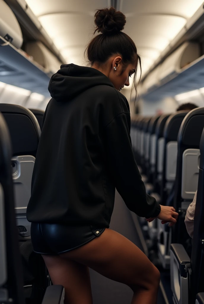 black woman hair in a bun black hoodie black leather short short bending over the seat in front of her getting something on the plane. backside view hyper realistic 8k clothe folding
