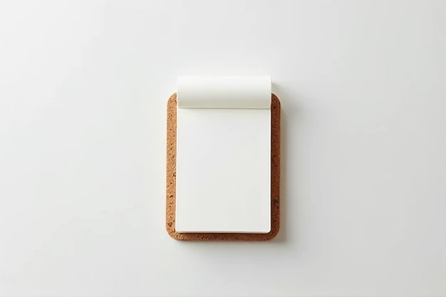 The image shows a small, compact notepad with blank sheets, slightly highlighted by the curved edge at the top. The design is minimalist, with a simple binding at the top that allows for easy detachment of the pages. The background, originally in a beige t...